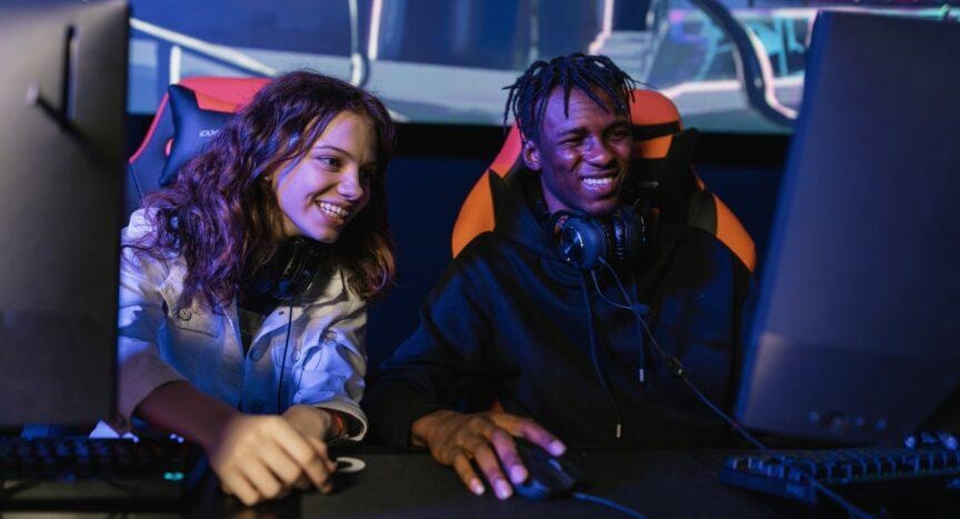 Two young people gaming together at computers